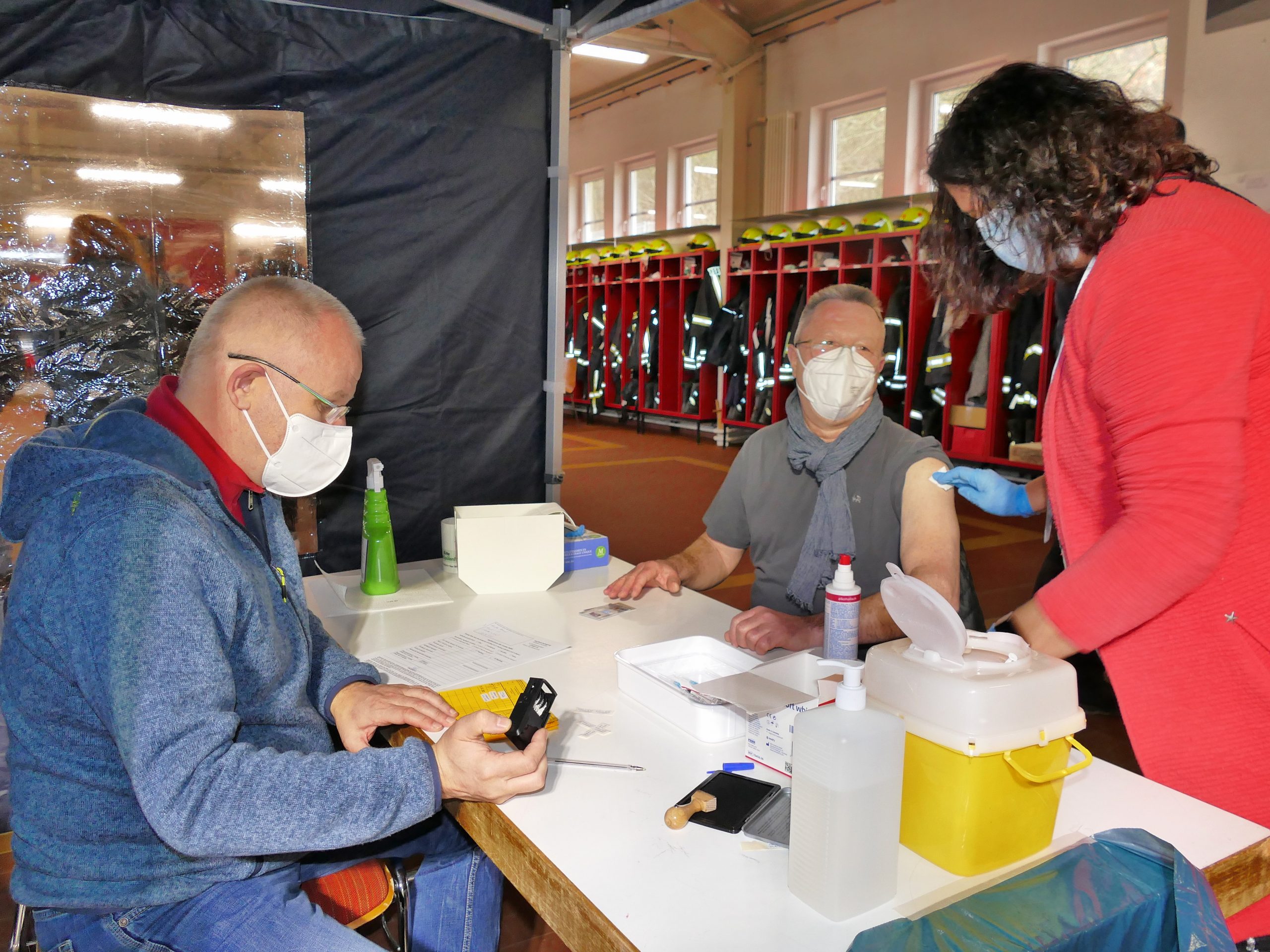 Karsten Konrad von der Löschgruppe Wilgersdorf holt sich bei Dr. Michael Brock und Arzthelferin Martina Jantz den Booster-Piks